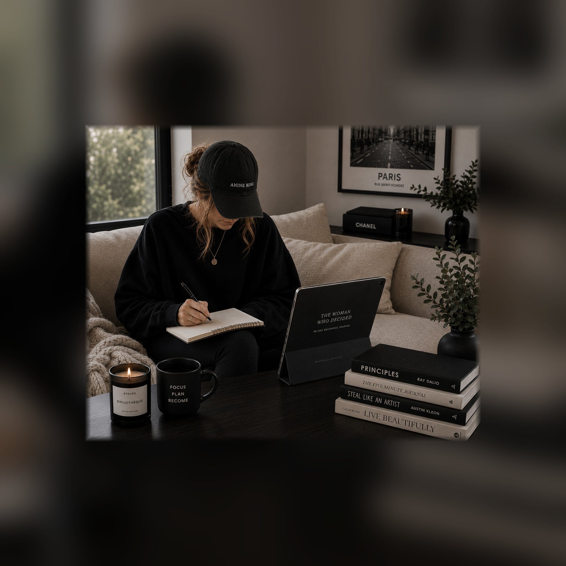 The Woman Who Decided 90-day journal on a tablet — couch black and white lifestyle mockup, full-bleed square