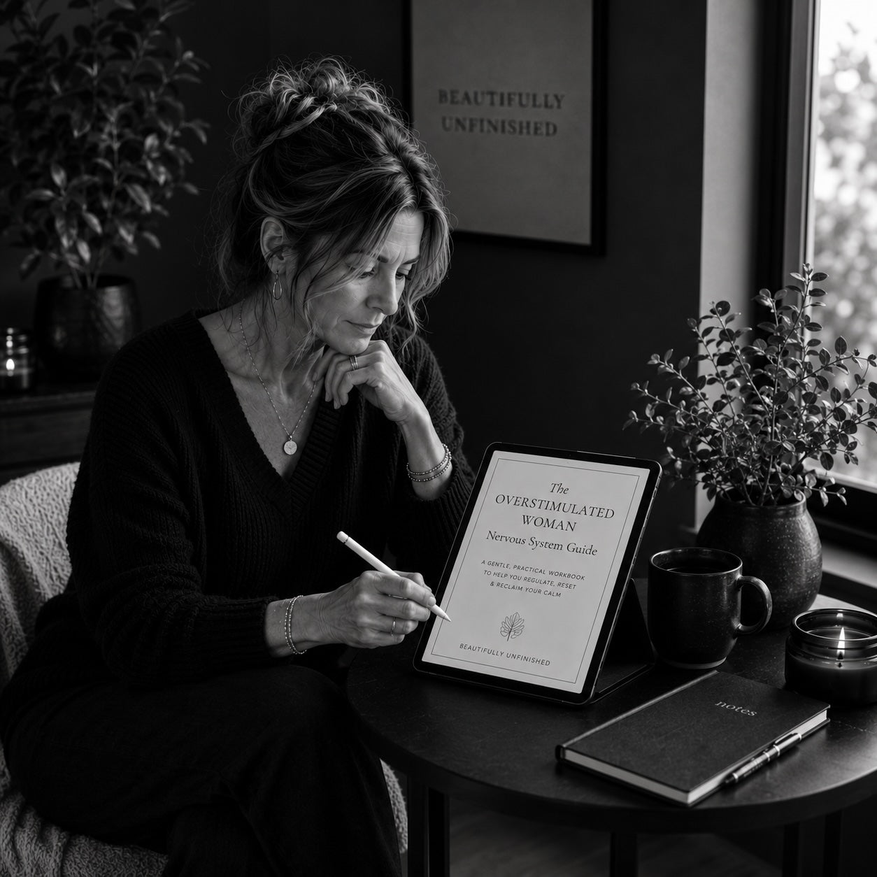 Woman working through The Overstimulated Woman guide — black and white lifestyle mockup