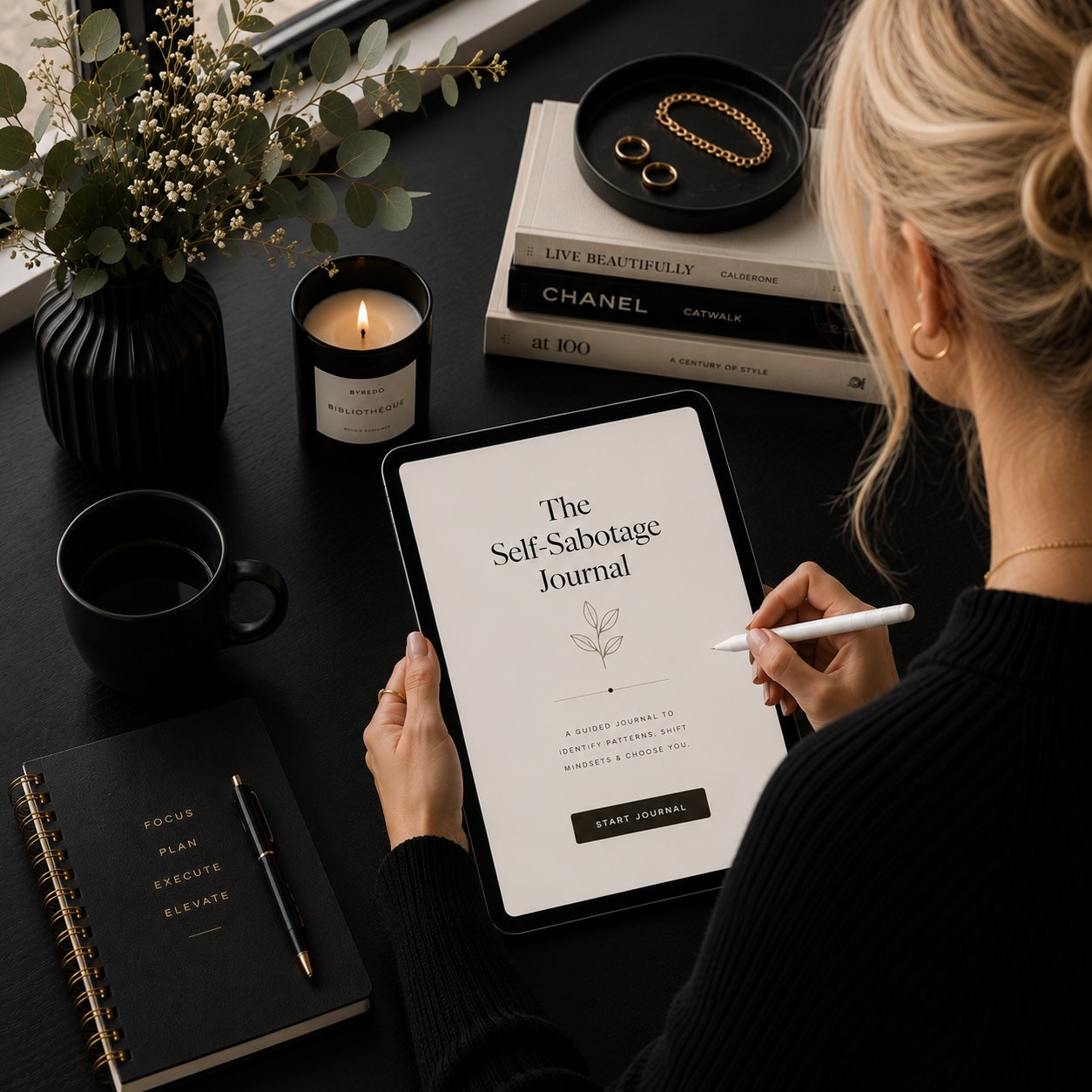 Woman journaling with The Unfinished Woman self-sabotage journal — monochrome mockup 2