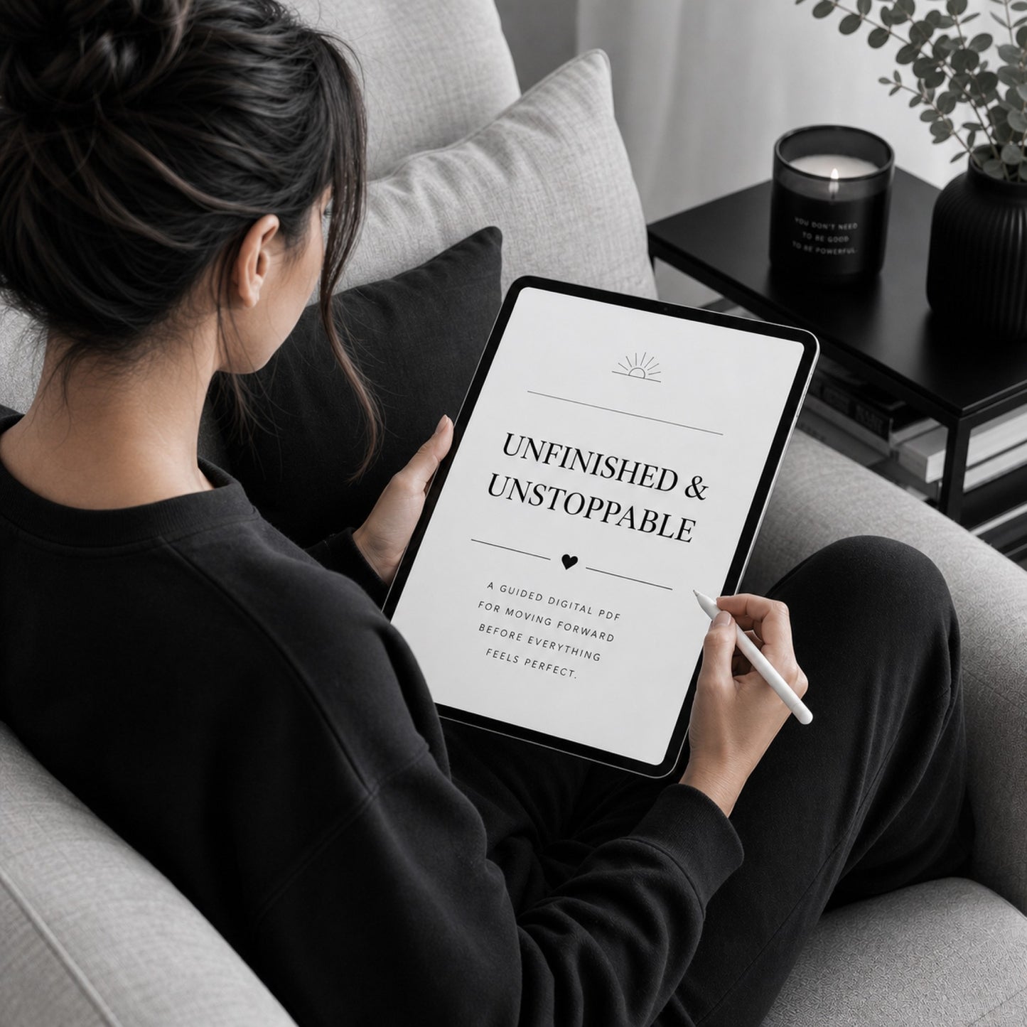 Woman reading Unfinished & Unstoppable perfectionism guide — sofa lifestyle mockup